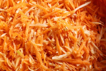 grated carrots vegetables salad as background