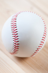 Vertical shot of a baseball ball on wooden boards