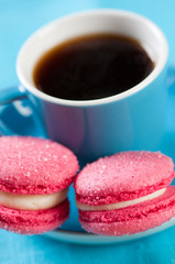 French macaroons and a cup of espresso, close-up, vertical shot