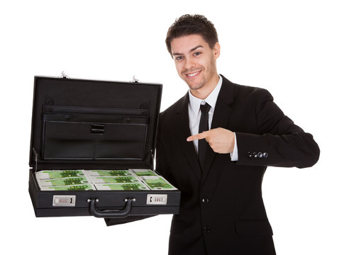 Businessman with suitcase full of cash