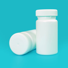 white pill bottles on blue background