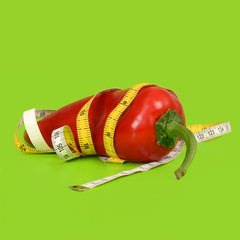 Red pepper wrapped with a measuring tape