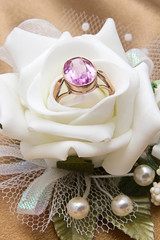 Gold engagement ring with gemstone in cream rose
