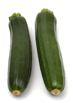 Two fresh vegetable zucchini isolated on white background.