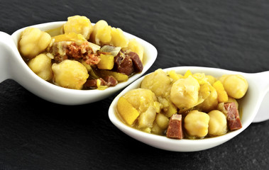 Couple chickpea stew on a slate table mats.