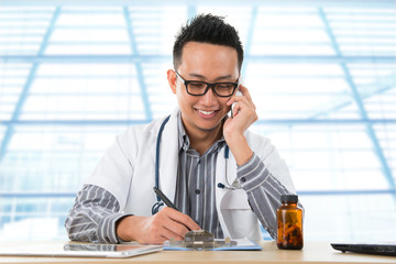 Asian medical doctor working on desk
