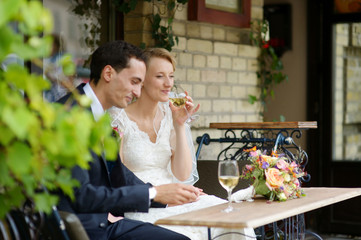 Bride and groom drinking wine
