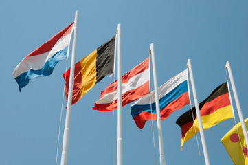 Flags of different countries on a background of blue sky