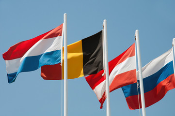Flags of different countries on a background of blue sky