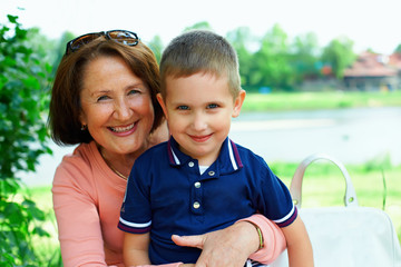 happy grandmother and grandchild embracing outside