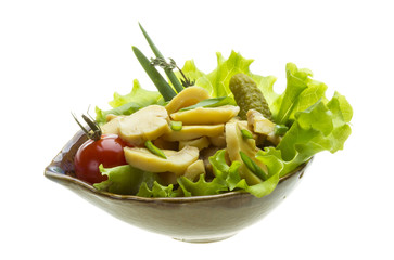 Marinated mushrooms in white saucer isolated on white