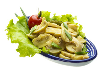 Marinated mushrooms in white saucer isolated on white