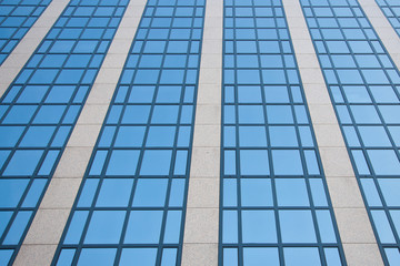 blue sky reflected in grid of windows