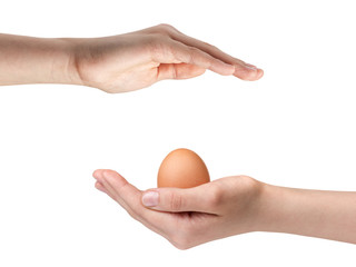 female teen hand holding egg