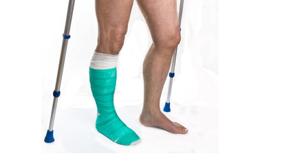 Man with a broken leg with Crutches on a white background