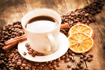 Tastefully presented with a cup of coffee, and orange slices.