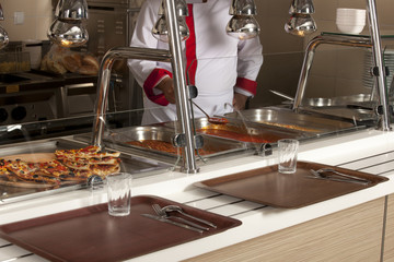 chef standing behind full lunch service station 
