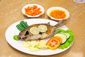 fried fish seafood with vegetable and chili sauce asian food
