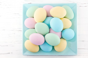 Fototapeta na wymiar Pastel color easter eggs on a plate