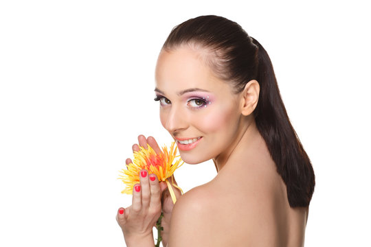 Beautiful young woman with a flower.