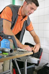 Plumber working in the bathroom