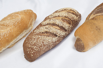 Selection of bread loaves on white
