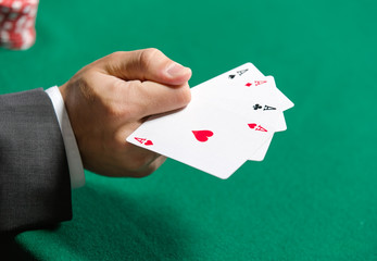 Gambler shows poker cards 4 aces. Addiction to the gambling