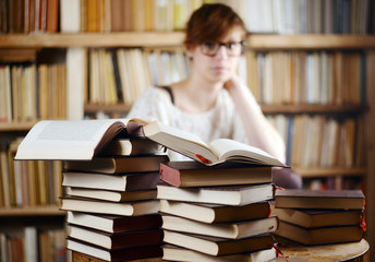 Woman behind a pile of books
