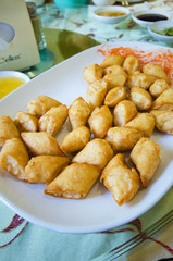 Fried dumplings served on white plate