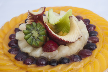 Closeup of fruit tart on white