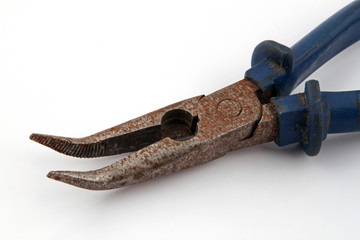 Old rusty pliers on a plain white background