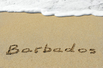 Conceptual handwritten text Barbados in sand