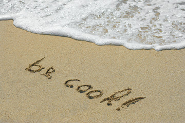 Be cool handwritten in sand