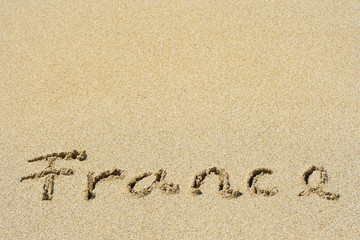 Conceptual handwritten text France in sand