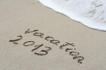 Fototapeta premium Conceptual handwritten 2013 year text in sand