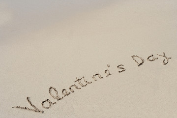 Conceptual handwritten text Valentine`s Day in sand