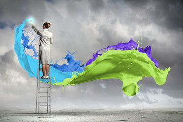 Young woman drawing splashes