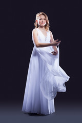 Fototapeta na wymiar Young woman in beautiful long dress