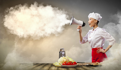 Asian female cook holding megaphone