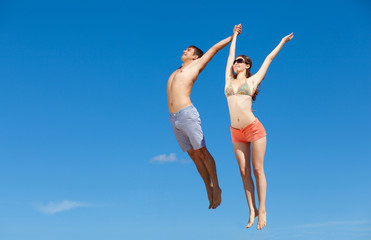 Happy Young Couple Together On The Beach