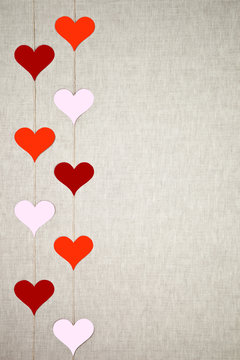 Hearts garlands on linen background