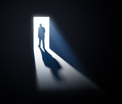 Man walking out into light