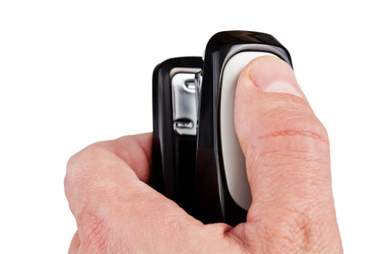 Hand holding black stapler, isolated on white