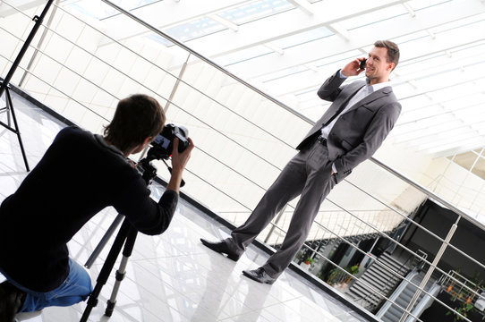 photographer shoots a business man with phone