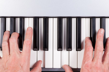 Hands playing a keyboard