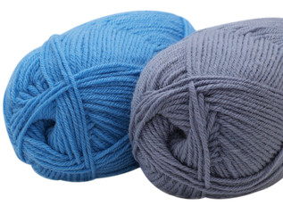 Two skeins of yarn on white background