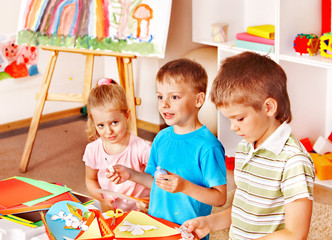 Child cutting out scissors paper.