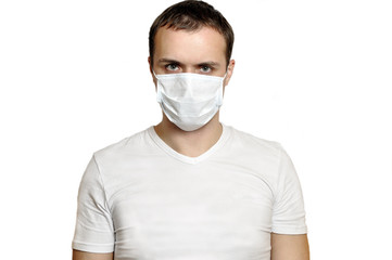 Sick young man in medical mask looking