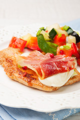chicken fillet baked with mozzarella, Parma ham and vegetables