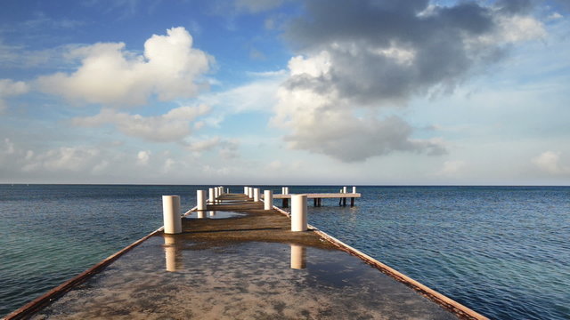 Morning pier stretching into the horizon of the Caribbean